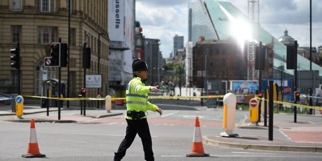 A police officer potrols a cordon near to the Manchester Arena in Manchester, northwest England on May 23, 2017 following a deadly terror attack at the Ariana Grande concert at the Manchester Arena the night before. Twenty two people have been killed and dozens injured in Britain's deadliest terror attack in over a decade after a suspected suicide bomber targeted fans leaving a concert of US singer Ariana Grande in Manchester. / AFP PHOTO / Oli SCARFF        (Photo credit should read OLI SCARFF/