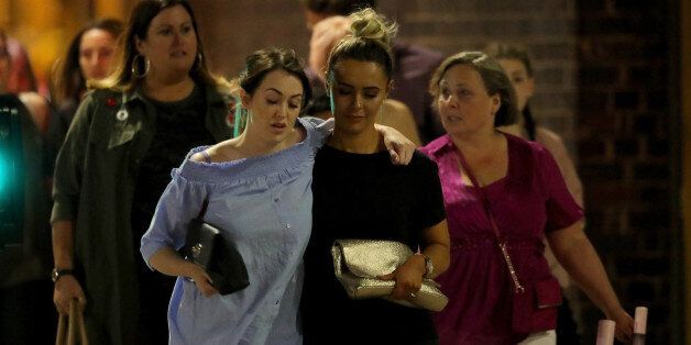 MANCHESTER, ENGLAND - MAY 23:  Police escort members of the public from the Manchester Arena on May 23, 2017 in Manchester, England.  An explosion occurred at Manchester Arena as concert goers were leaving the venue after Ariana Grande had performed.  Greater Manchester Police have confirmed 19 fatalities and at least 50 injured. (Photo by Christopher Furlong/Getty Images)
