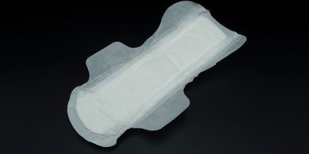 White clean hygiene sanitary napkin which soft and comfortable gently to skin on black background.
