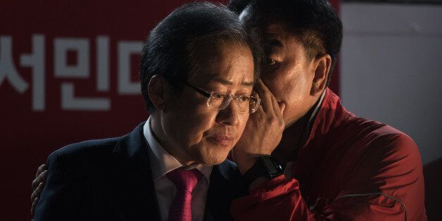 South Korean presidential candidate Hong Jun-Pyo (L) prepares to give a speech during a campaign rally in Seoul on May 8, 2017.South Korea's presidential hopefuls made a final push for votes on May 8, with the left-leaning candidate a clear favourite, as the North assailed the outgoing conservative government a day before the polls. / AFP PHOTO / Ed JONES        (Photo credit should read ED JONES/AFP/Getty Images)