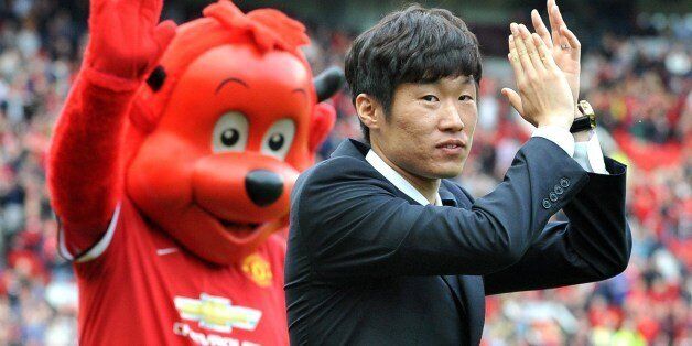 Former Manchester United Korean player Ji-Sung Park is announced as a club ambassador before the start of the English Premier League football match between Manchester United and Everton at Old Trafford in Manchester, Northwest England, on October 5, 2014. AFP PHOTO/PAUL ELLIS == RESTRICTED TO EDITORIAL USE. NO USE WITH UNAUTHORIZED AUDIO, VIDEO, DATA, FIXTURE LISTS, CLUB/LEAGUE LOGOS OR 'LIVE' SERVICES. ONLINE IN-MATCH USE LIMITED TO 45 IMAGES, NO VIDEO EMULATION. NO USE IN BETTING, GAMES OR SINGLE CLUB/LEAGUE/PLAYER PUBLICATIONS. ==        (Photo credit should read PAUL ELLIS/AFP/Getty Images)