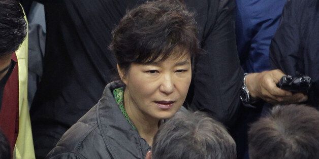 JINDO-GUN, SOUTH KOREA - APRIL 17:  South Korean President Park Geun-Hye talks with relatives of missing passengers of a sunken ferry at Jindo gymnasium on April 17, 2014 in Jindo-gun, South Korea. Six are dead, and 290 are missing as reported. The ferry identified as the Sewol was carrying about 470 passengers, including the students and teachers, traveling to Jeju Island.  (Photo by Chung Sung-Jun/Getty Images)