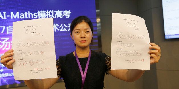 CHENGDU, CHINA - JUNE 07:  A staff member shows the scores of math tests taken by the robot AI-Maths on June 7, 2017 in Chengdu, Sichuan Province of China. Robot AI-Maths, developed by a tech firm in Chengdu, sit match tests of 2017 national college entrance exam (aka Gaokao) on Wednesday evening in Chengdu. The AI-Maths finished the math test for Beijing liberal arts students in 22 minutes with a score of 105, and the national exam paper II's math test for liberal arts students in 10 minutes wi