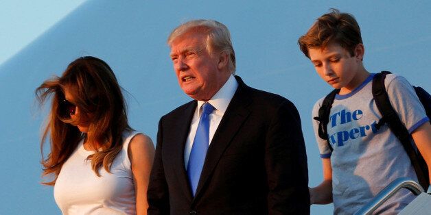 U.S. President Donald Trump with First Lady Melania Trump and their son Barron arrive at Joint Base Andrews outside Washington, U.S., after a weekend at Trump National Golf Club in Bedminster, New Jersey, U.S., June 11, 2017. REUTERS/Yuri Gripas     TPX IMAGES OF THE DAY
