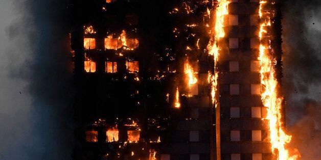 Flames and smoke billow as firefighters deal with a serious fire in a tower block at Latimer Road in West London, Britain June 14, 2017. REUTERS/Toby Melville