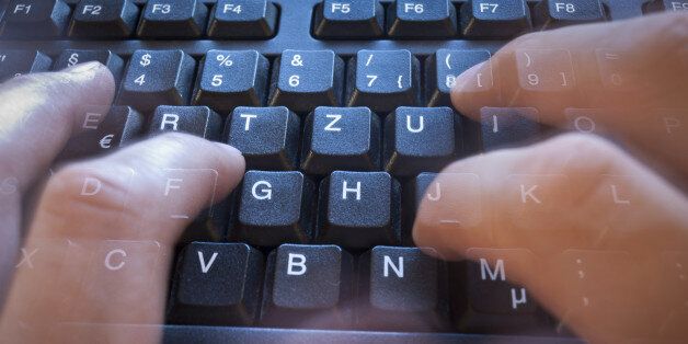 Finger in motion on tack sharp keyboard.