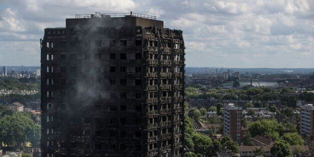 LONDON, ENGLAND - JUNE 15:  Debris hangs from the blackened exterior of Grenfell Tower on June 15, 2017 in London, England. At least 17 people have been confirmed dead and dozens missing, after the 24 storey residential Grenfell Tower block in Latimer Road was engulfed in flames in the early hours of June 14. The number of fatalities are expected to rise.  (Photo by Dan Kitwood/Getty Images)