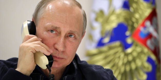 Russian President Vladimir Putin speaks by phone with his Turkish counterpart from aboard the Pioneering Spirit pipelaying ship in the Black Sea on June 23, 2017.Russian President Vladimir Putin on Friday launched the deep-water phase of the TurkStream gas pipeline project, calling Turkey's Recep Tayyip Erdogan from a ship off the Black Sea coast. TurkStream will deliver Russian gas to Turkey and is eventually intended to serve the European Union. / AFP PHOTO / SPUTNIK / Mikhail KLIMENTYEV
