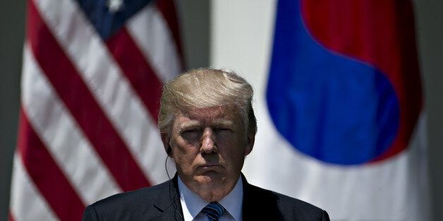 U.S. President Donald Trump listens during a joint statement with Moon Jae-in, South Korea's president, not pictured, in the Rose Garden of the White House in Washington, D.C., U.S., on Friday, June 30, 2017. Trump wants South Korea to reduce barriers to U.S. auto exports to the country and is concerned by the 'enormous' amount of surplus steel the U.S. imports from the country, especially shipments that come via China, a White House administration official said this week. Photographer: Andrew H