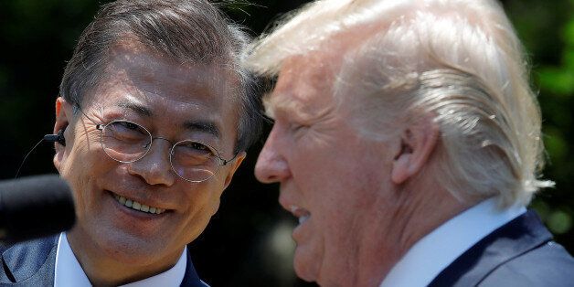 South Korean President Moon Jae-in looks at U.S. President Donald Trump after delivering a joint statement from the Rose Garden of the White House in Washington, U.S., June 30, 2017. REUTERS/Carlos Barria