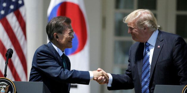 U.S. President Donald Trump (R) greets South Korean President Moon Jae-in prior to delivering a joint statement from the Rose Garden of the White House in Washington, U.S., June 30, 2017. REUTERS/Jim Bourg     TPX IMAGES OF THE DAY
