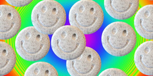 Ecstasy. Tablets of the illegal drug ecstasy (3, 4- methylenedioxymethamphetamine or MDMA). Ecstasy induces feelings of elation, energy and well- being. Possible side effects include dehydration, involuntary muscle movements and psychological difficulties. There is some evidence that long term use may cause brain damage. The smiley symbol on the tablets was an emblem adopted by the 1980s acid house dance music culture that popularised the use of ecstasy as a recreational drug.