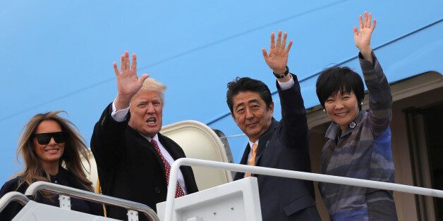 U.S. President Donald Trump and his wife Melania (L) wave with Japanese Prime Minister Shinzo Abe (2nd R) and his wife Akie Abe while boarding Air Force One as they depart for Palm Beach, Florida, at Joint Base Andrews, Maryland, U.S., February 10, 2017. REUTERS/Carlos Barria