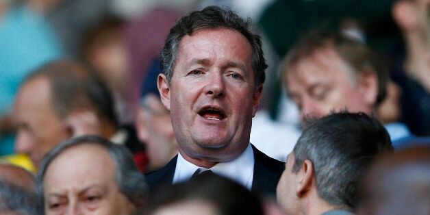Former newspaper editor Piers Morgan takes his seat in the stand before Arsenal play Tottenham Hotspur in their English Premier League soccer match at White Hart Lane in London, March 16, 2014. REUTERS/Eddie Keogh (BRITAIN - Tags: SPORT SOCCER MEDIA) FOR EDITORIAL USE ONLY. NOT FOR SALE FOR MARKETING OR ADVERTISING CAMPAIGNS. NO USE WITH UNAUTHORIZED AUDIO, VIDEO, DATA, FIXTURE LISTS, CLUB/LEAGUE LOGOS OR