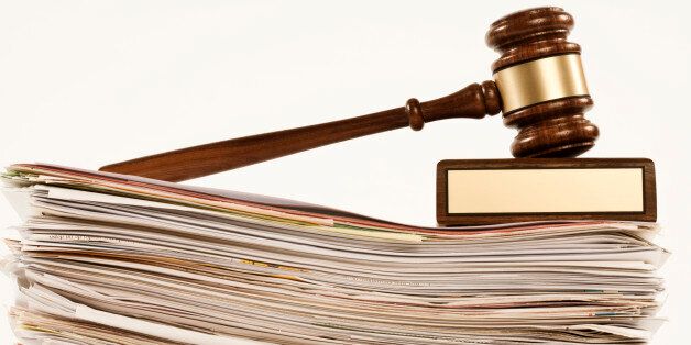 gavel on stack of documents on white background