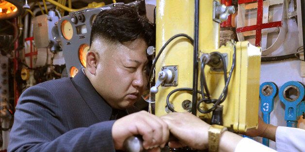 North Korean leader Kim Jong Un looks through a periscope of a submarine during his inspection of the Korean People's Army (KPA) Naval Unit 167 in this undated photo released by North Korea's Korean Central News Agency (KCNA) in Pyongyang June 16, 2014. REUTERS/KCNA (NORTH KOREA - Tags: POLITICS MILITARY MARITIME TPX IMAGES OF THE DAY) ATTENTION EDITORS - THIS PICTURE WAS PROVIDED BY A THIRD PARTY. REUTERS IS UNABLE TO INDEPENDENTLY VERIFY THE AUTHENTICITY, CONTENT, LOCATION OR DATE OF THIS IMAGE. THIS PICTURE WAS PROCESSED BY REUTERS TO ENHANCE QUALITY. AN UNPROCESSED VERSION WAS PROVIDED SEPARATELY. FOR EDITORIAL USE ONLY. NOT FOR SALE FOR MARKETING OR ADVERTISING CAMPAIGNS. THIS IMAGE HAS BEEN SUPPLIED BY A THIRD PARTY. IT IS DISTRIBUTED, EXACTLY AS RECEIVED BY REUTERS, AS A SERVICE TO CLIENTS. NO THIRD PARTY SALES. NOT FOR USE BY REUTERS THIRD PARTY DISTRIBUTORS. SOUTH KOREA OUT. NO COMMERCIAL OR EDITORIAL SALES IN SOUTH KOREA