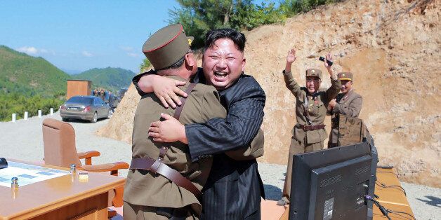 TOPSHOT - This picture taken on July 4, 2017 and released by North Korea's official Korean Central News Agency (KCNA) on July 5, 2017 shows North Korean leader Kim Jong-Un (C) celebrating the successful test-fire of the intercontinental ballistic missile Hwasong-14 at an undisclosed location.South Korea and the United States fired off missiles on July 5 simulating a precision strike against North Korea's leadership, in response to a landmark ICBM test described by Kim Jong-Un as a gift to 'Ameri