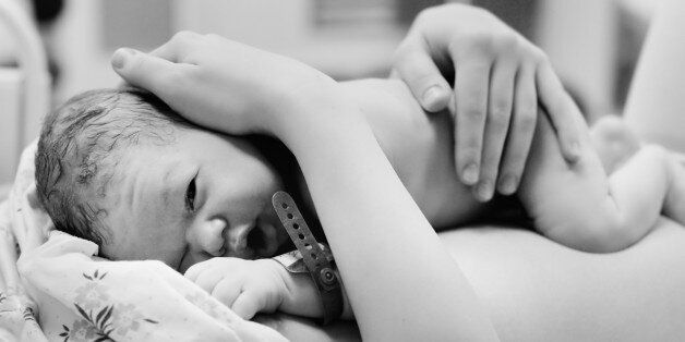 Black and white shot of newborn baby right after delivery