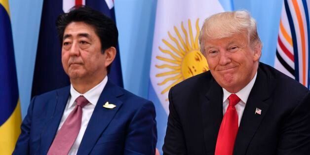 US President Donald Trump (R) and Japan's Prime Minister Shinzo Abe attend the panel discussion  'Launch Event Women's Entrepreneur Finance Initiative' on the second day of the G20 Summit in Hamburg, Germany, July 8, 2017.Leaders of the world's top economies gather from July 7 to 8, 2017 in Germany for likely the stormiest G20 summit in years, with disagreements ranging from wars to climate change and global trade. / AFP PHOTO / SAUL LOEB        (Photo credit should read SAUL LOEB/AFP/Getty Imag