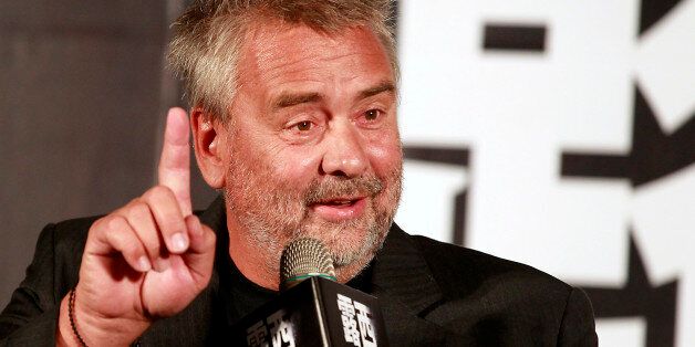 French film director Luc Besson gestures while answering a question during a news conference to promote his latest movie