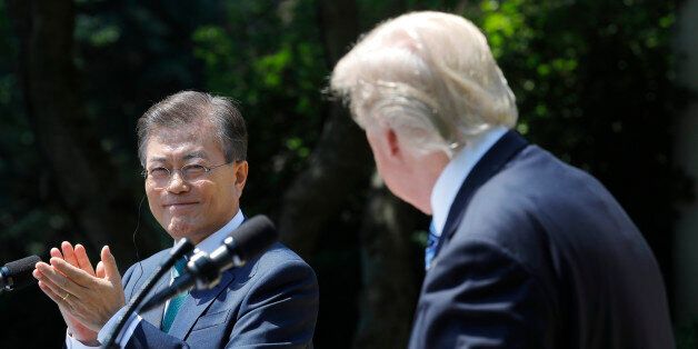 South Korean President Moon Jae-in (L) applauds next to U.S. President Donald Trump while delivering a joint statement from the Rose Garden of the White House in Washington, U.S., June 30, 2017. REUTERS/Carlos Barria