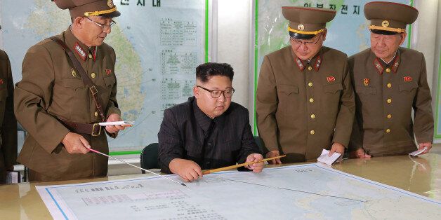 TOPSHOT - This picture taken on August 14, 2017 and released from North Korea's official Korean Central News Agency (KCNA) on August 15, 2017 shows North Korean leader Kim Jong-Un (C) inspecting the Command of the Strategic Force of the Korean People's Army (KPA) at an undisclosed location.North Korean leader Kim Jong-Un said on August 15 he would hold off on a planned missile strike near Guam, but warned the highly provocative move would go ahead in the event of further 'reckless actions' by Washington. / AFP PHOTO / KCNA VIA KNS / STR / South Korea OUT / REPUBLIC OF KOREA OUT   ---EDITORS NOTE--- RESTRICTED TO EDITORIAL USE - MANDATORY CREDIT 'AFP PHOTO/KCNA VIA KNS' - NO MARKETING NO ADVERTISING CAMPAIGNS - DISTRIBUTED AS A SERVICE TO CLIENTSTHIS PICTURE WAS MADE AVAILABLE BY A THIRD PARTY. AFP CAN NOT INDEPENDENTLY VERIFY THE AUTHENTICITY, LOCATION, DATE AND CONTENT OF THIS IMAGE. THIS PHOTO IS DISTRIBUTED EXACTLY AS RECEIVED BY AFP.  /         (Photo credit should read STR/AFP/Getty Images)
