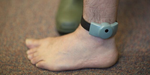An electronic tag around an ankle