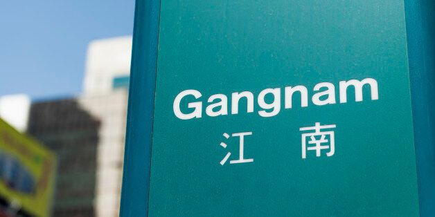A sign for Gangnam subway station.  Gangnam is a district located south of the Han River in South Korea's capital city, Seoul.