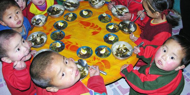 PYONGAN, NORTH KOREA - FEBRUARY 21:  North Korean children eat lunch, including rice, provided by the United Nations World Food Programme, at a nursery on February 21, 2005 in Yomju county, North Pyongan province in North Korea. The WFP and UNICEF have stated that while child malnutrition rates in North Korea fell during the last two years, continued international assistance is needed to build on the gains. (Photo by Gerald Bourke/WFP via Getty Images)