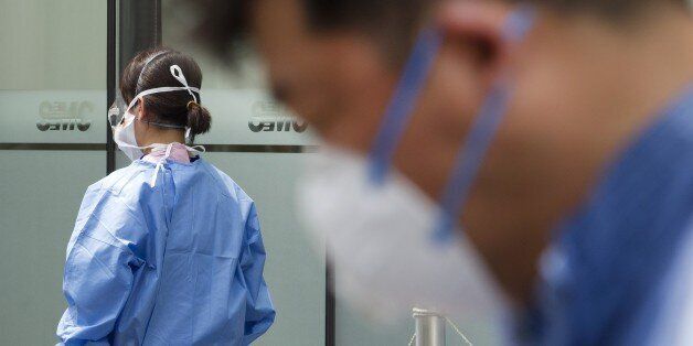 SEOUL, SOUTH KOREA - JUNE 15: A hospital worker wearing protective gear preparing medical on quarantine tent for people who could be infected with the MERS virus at Samsung Medical Center on June 15, 2015 in Seoul, South Korea. (Photo by Kim Jong Hyun/Anadolu Agency/Getty Images)