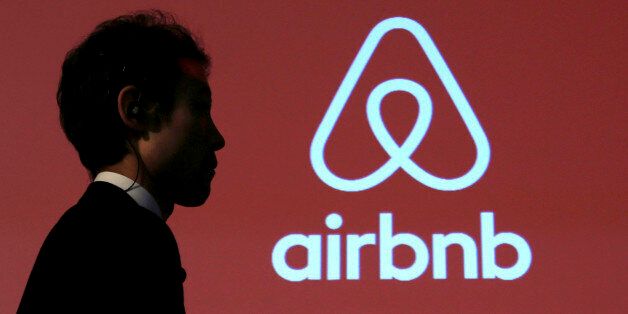 A man walks past a logo of Airbnb after a news conference in Tokyo, Japan, November 26, 2015. REUTERS/Yuya Shino/File Photo