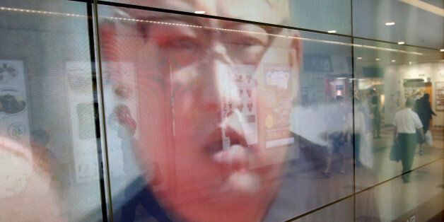 Passersby are reflected in a TV screen reporting news about North Korea's leader Kim Jong Un and their missile launch, in Tokyo, Japan, September 15, 2017.  REUTERS/Issei Kato