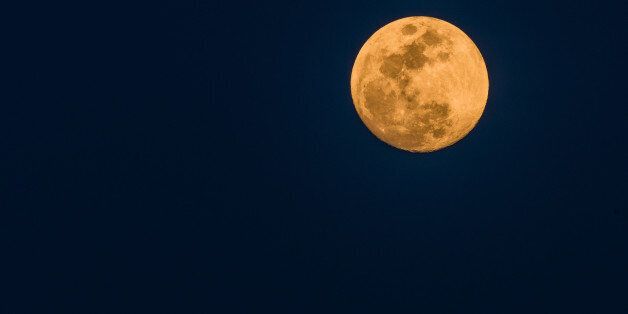 March full moon on a dark blue background as seen from Daejeon, South Korea using a Nikon D500 and a Nikon 200 to 500mm lens at 500mm