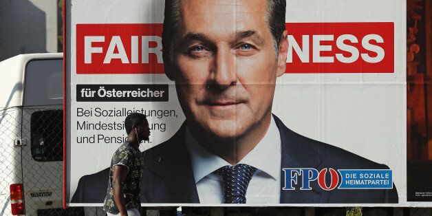 VIENNA, AUSTRIA - OCTOBER 14:  A man of African origin walks past an election campaign billboard that shows Heinz-Christian Strache, lead candidate of the right-wing Austria Freedom Party (FPOe), on October 14, 2017 in Vienna, Austria. Austria faces parliamentary elections on October 15 and the FPOe, which is running on a 'fairness for Austrians' campaign with strong anti-immigrant, anti-refugee and anti-Islam tones, is currently in third place in polls and could well become a coalition partner