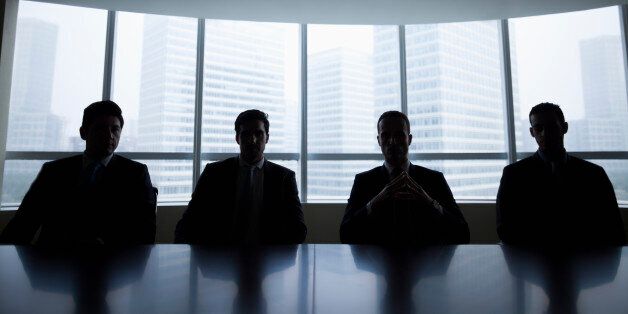Silhouette row of businessmen sitting in meeting room