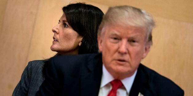US Ambassador to the UN Nikki Haley and US President Donald Trump wait for a a meeting on United Nations Reform at UN headquarters in New York on September 18, 2017. / AFP PHOTO / Brendan Smialowski        (Photo credit should read BRENDAN SMIALOWSKI/AFP/Getty Images)