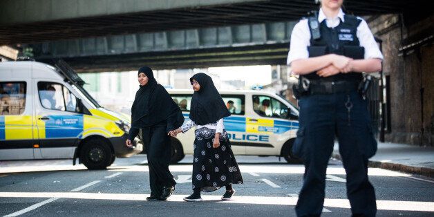 LONDON, UNITED KINGDOM - JUNE 19: A muslim woman and child hold hands and walk past police near the scene of the terror attack in Finsbury Park on June 19, 2017 in London, England. PHOTOGRAPH BY Adam Gray / Barcroft ImagesLondon-T:+44 207 033 1031 E:hello@barcroftmedia.com -New York-T:+1 212 796 2458 E:hello@barcroftusa.com -New Delhi-T:+91 11 4053 2429 E:hello@barcroftindia.com www.barcroftimages.com (Photo credit should read Adam Gray / Barcroft Images / Barcroft Media via Getty Images)
