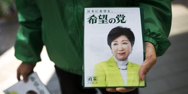In this picture taken on October 18, 2017, a man distributes electoral leaflets of Tokyo Governor and leader of the Party of Hope Yuriko Koike during an election campaign in Saitama.Tokyo governor Yuriko Koike is a media-savvy veteran who has charmed her way through Japan's male-dominated politics and transformed its sleepy political landscape with a wildcard new party that caught everyone off-guard. Koike stunned the establishment by unveiling her new conservative 'Party of Hope', seeking to of