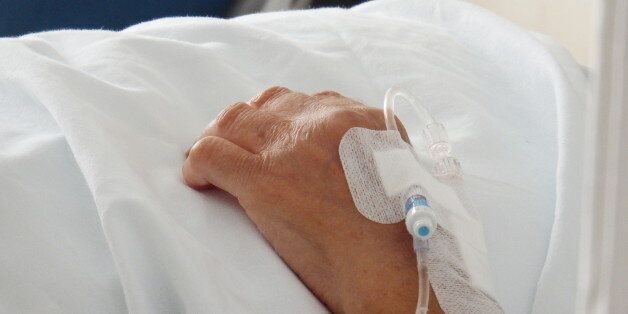 Patient in hospital bed with intravenous route