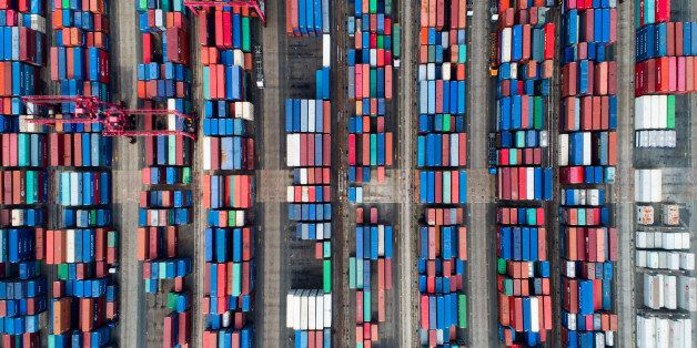 Shipping containers sit stacked in this aerial photograph taken above the Busan Port Terminal (BPT) in Busan, South Korea, on Monday, July 17, 2017. South Korea's exports will continue to rise in July and the third quarter as global trade continues to recover and unit costs rise, especially in sectors including semiconductors, vessels, petroleum goods and steel, according to a statement from the trade ministry. Photographer: SeongJoon Cho/Bloomberg via Getty Images