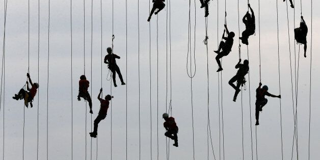 People climb after jumping off a bridge, which has a height of 30 meters, in Hortolandia, Brazil, October 22, 2017. According to organizers, 245 people were attempting set a new world record for