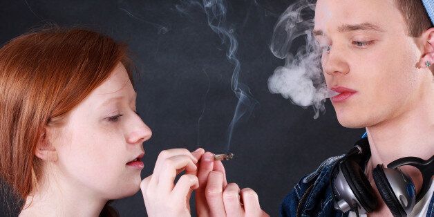 Horizontal view of a teenagers smoking marijuana joint