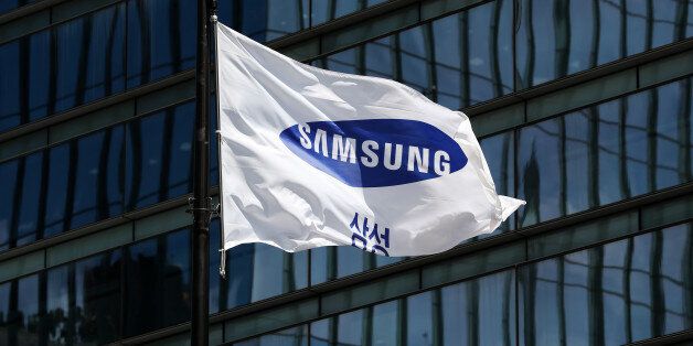 The Samsung Electronics Co. corporate flag flies outside the company's Seocho office building in Seoul, South Korea, on Tuesday, July 25, 2017. Samsung posted earnings that beat analysts' estimates on the success of its new Galaxy S8 smartphones and surging prices of semiconductors Photographer: SeongJoon Cho/Bloomberg via Getty Images