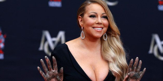 Singer Mariah Carey shows her hands after placing them in cement in the forecourt of the TCL Chinese theatre in Los Angeles, California, U.S., November 1, 2017. REUTERS/Mario Anzuoni