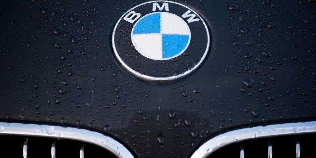 'Padua, Italy - July 6, 2011: Circle shape BMW logo and part of the front grill on a black car covered with dew drops. BMW (Bayerische Motoren Werke) is a German automobile, motorcycle and engine manufacturing company founded in 1916.'
