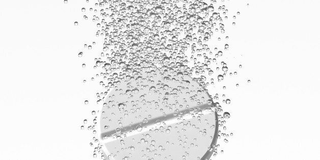 Effervescent medicine. Fizzy tablet dissolving. White round pill falling in water with bubbles. White background. 3D illustration