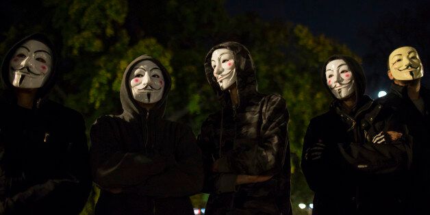 Protesters wearing Guy Fawkes masks stand in a park in downtown Belgrade November 5, 2014, on the day marking Guy Fawkes Night. REUTERS/Marko Djurica (SERBIA - Tags: SOCIETY ANNIVERSARY CIVIL UNREST)