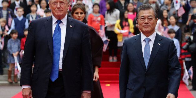 SEOUL, SOUTH KOREA - NOVEMBER 07:  South Korean President Moon Jae-In (R) and U.S. President Donald Trump (L) walk towards a guard of honour during a welcoming ceremony at the presidential Blue House on November 7, 2017 in Seoul, South Korea. Trump is in South Korea as a part of his Asian tour.  (Photo by Chung Sung-Jun/Getty Images)