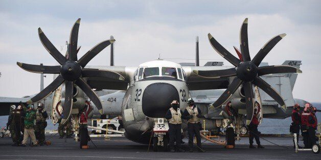 US Navy crew members stand by a C-2 Greyhound on the deck of the Nimitz-class aircraft carrier USS Carl Vinson during a South Korea-US joint military cxercise in seas east of the Korean Peninsula on March 14, 2017.The Carl Vinson Strike Group is participating in the annual joint Foal Eagle exercise between South Korea and the US. / AFP PHOTO / JUNG Yeon-Je        (Photo credit should read JUNG YEON-JE/AFP/Getty Images)