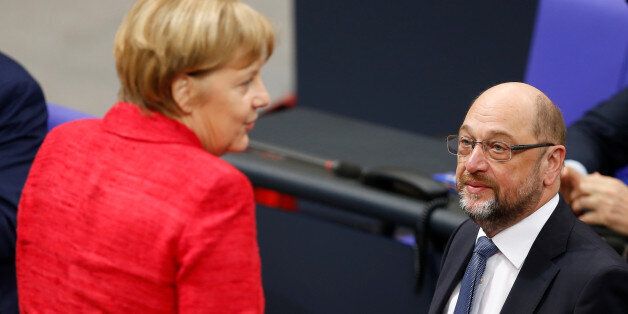 German Chancellor Angela Merkel speaks with Social Democratic Party (SPD) leader Martin Schulz as they attend a meeting of the Bundestag in Berlin, Germany, November 21, 2017. REUTERS/Axel Schmidt